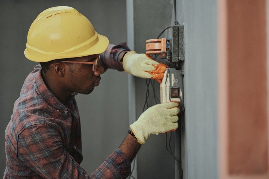 Electrician installing wiring on a Greenway project