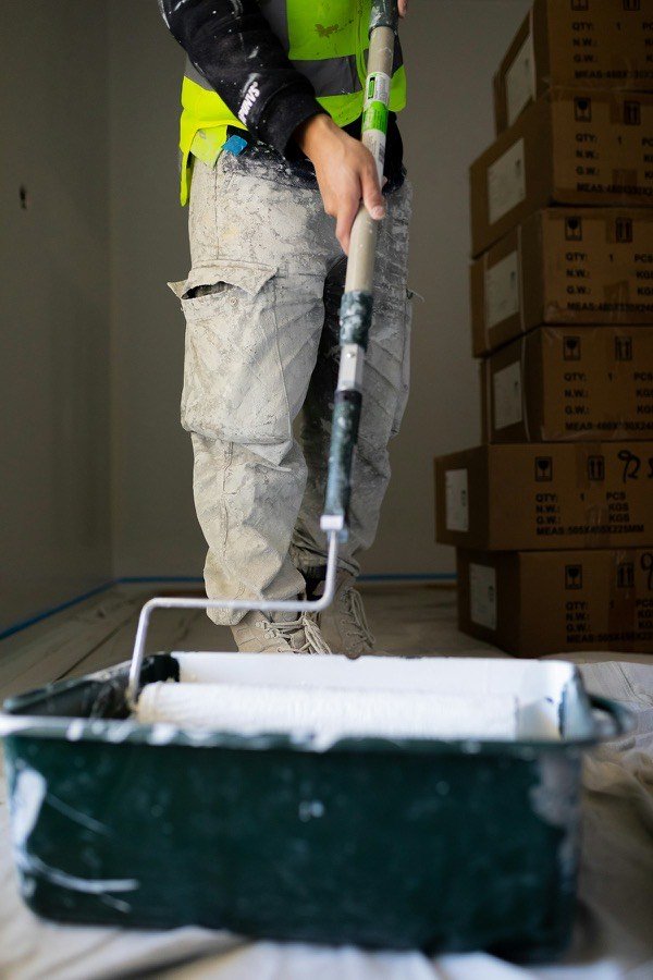 Painter applying finishing coat to an interior wall